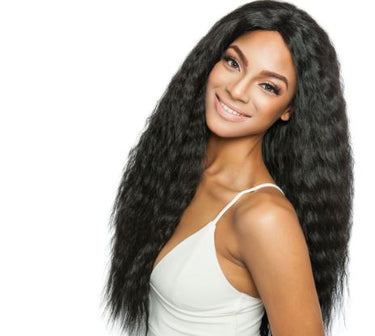 A woman showcasing long, wavy, black hair extensions with a smiling expression, wearing a white tank top.